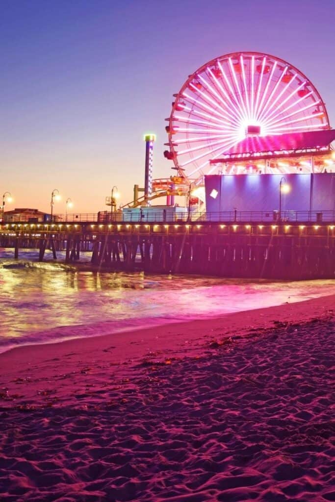 Neon pink colored photo of Santa Monica pier with beach and giant Ferris wheel