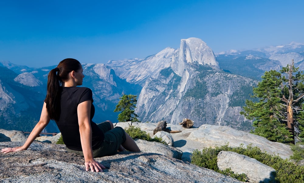 Woman sitting at Glacier Point in Yosemite National Park