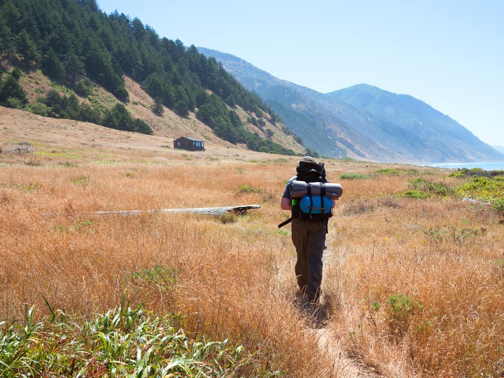 person walking on the lost coast trail in california