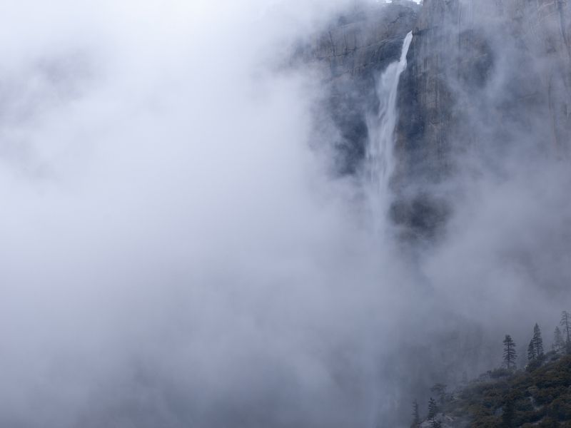 Lots of morning fog covering a large portion of Upper Yosemite Falls during the winter.