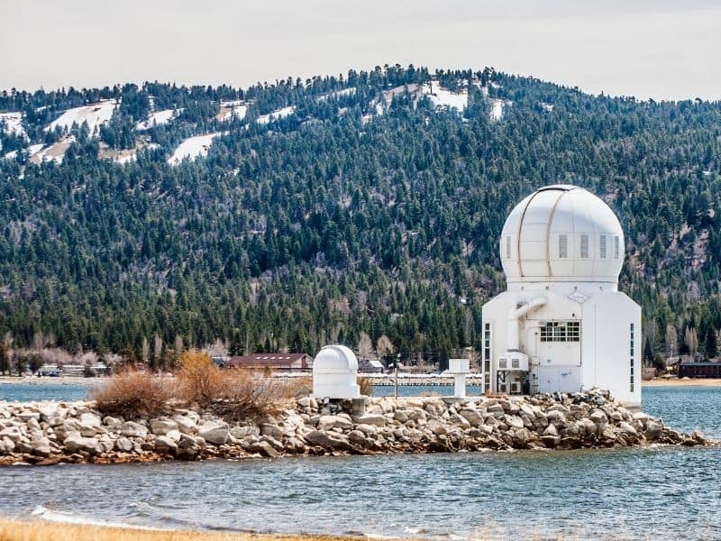 White building with dome roof that is an observatory in Big Bear Lake in winter