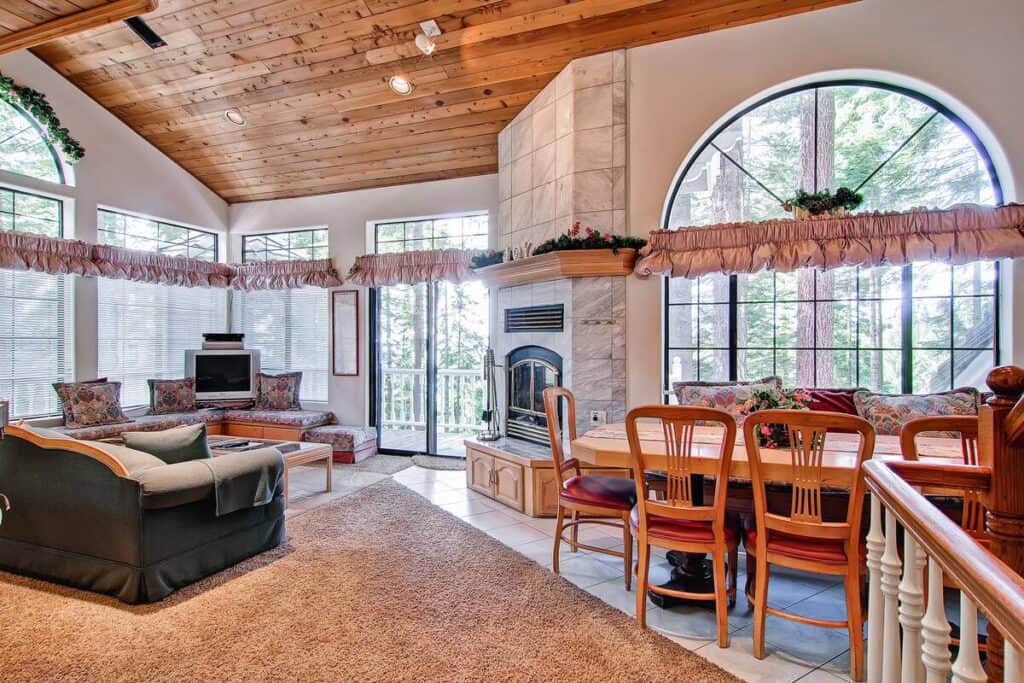 Living room with fireplace and long dining table and TV