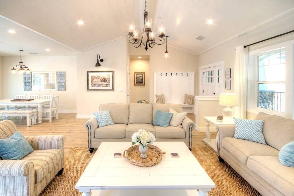 Bright white interior with tan sofas with light blue pops of color