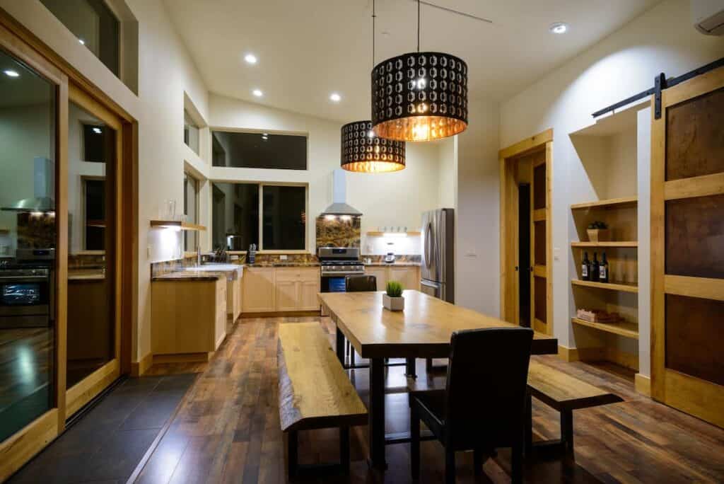 Interior at night with soft lighting and bench made of wood for communal dining