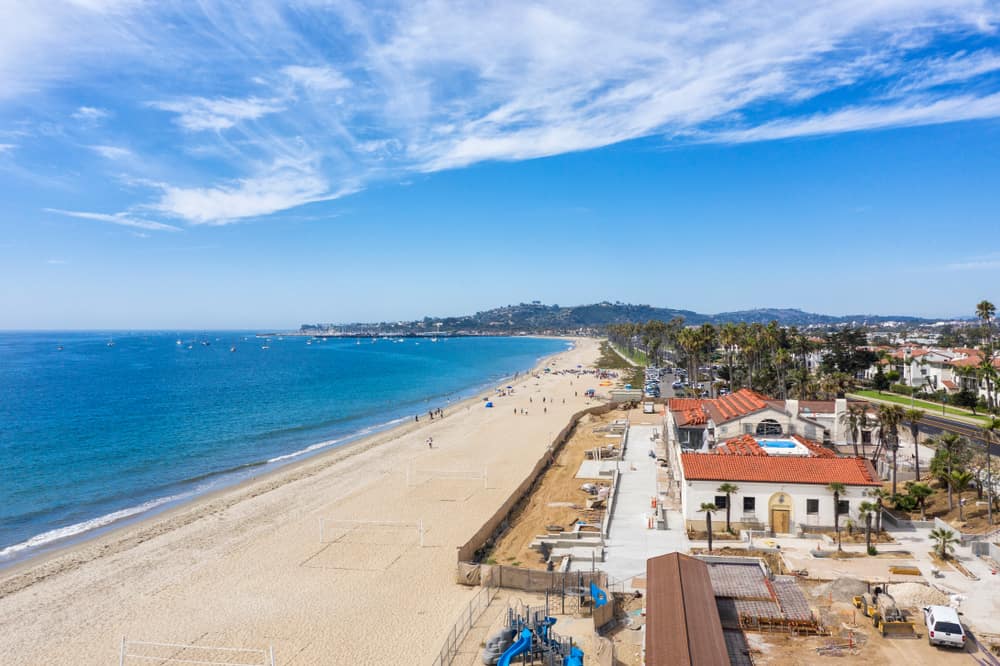 An aerial view of the Pacific Ocean of East Beach in Santa Barbara on a partly cloudy day.