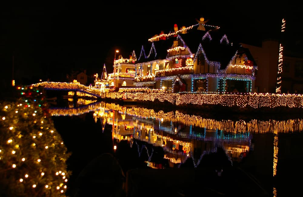 A lit up mansion with tons of Christmas lights on Venice Canals in Los Angeles at night