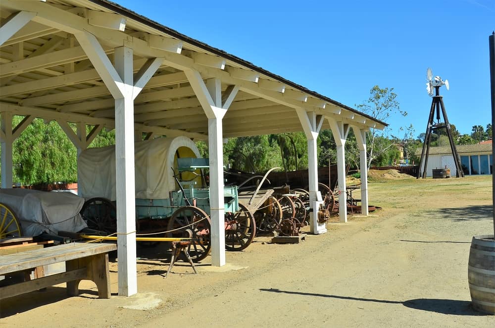 Western-looking part of Old San Diego with covered wagons parked under awning