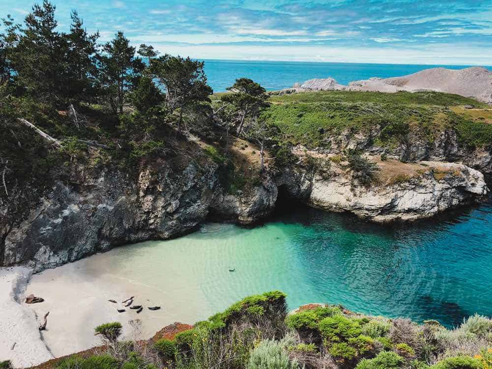 the crystal clear waters of china cove, turning from clear to deep turquoise, on a hike in big sur