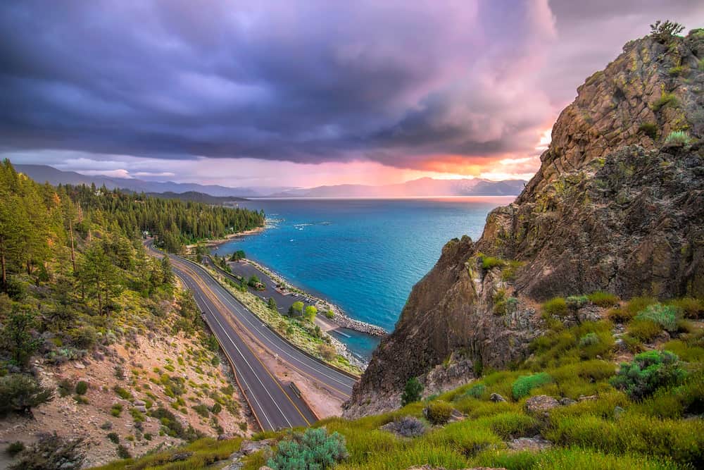 View of the Tahoe sunset from Cave Rock, the perfect way to end your weekend in Lake Tahoe itinerary