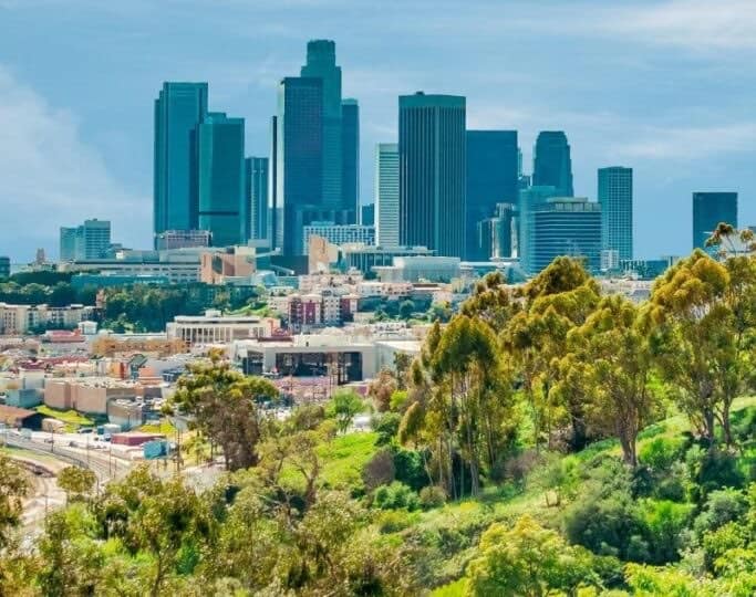 los angeles skyline from afar with greenery and skyscrapers