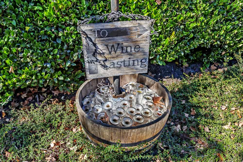 A sign that says "To wine tasting" with an arrow pointing to a wine tasting area in a Santa Barbara winery