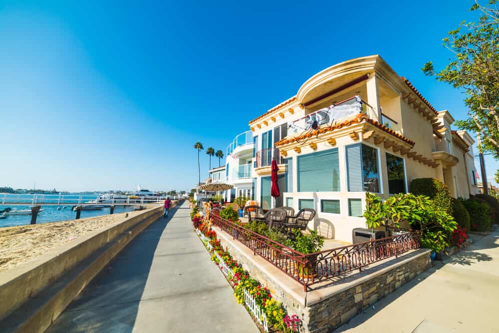 Colorful houses of Balboa Island on the oceanfront on a sunny day.