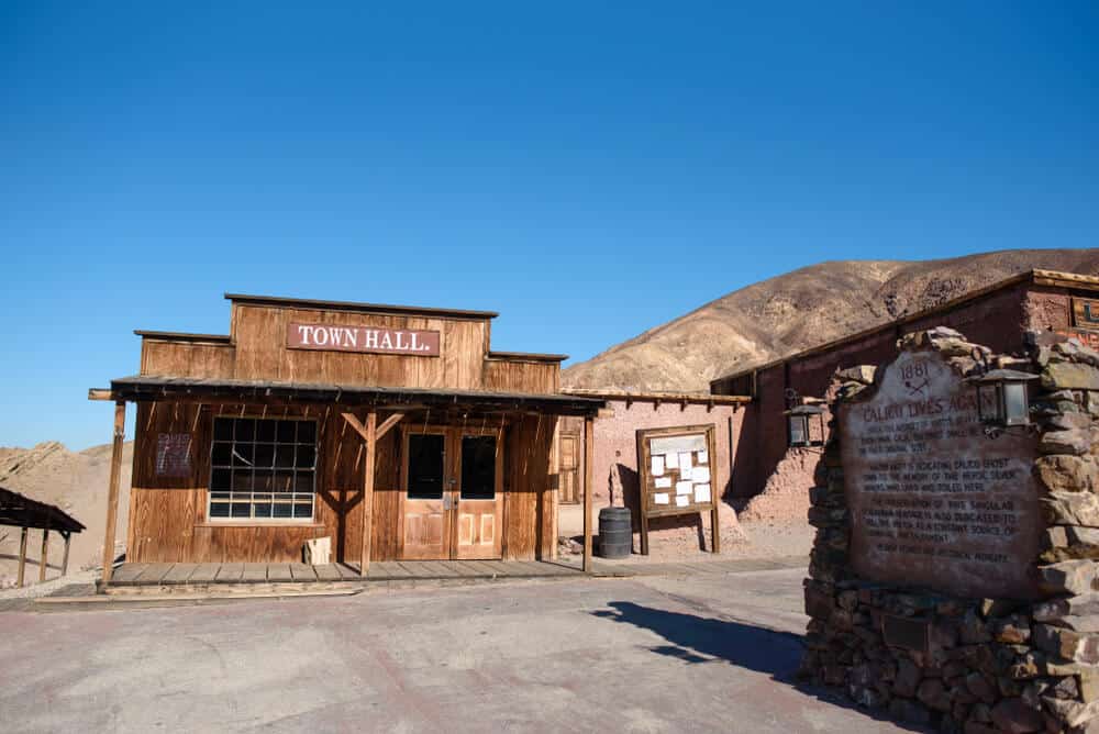 A wooden old-timey building that says "Town Hall" in the abandoned mining town of Calico, California, a road trip stop between Los Angeles and Las Vegas