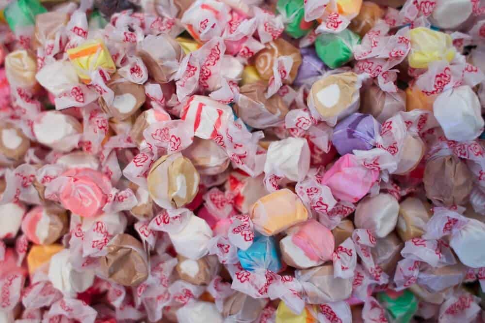 A pile of colorful saltwater taffies in a rainbow of colors.