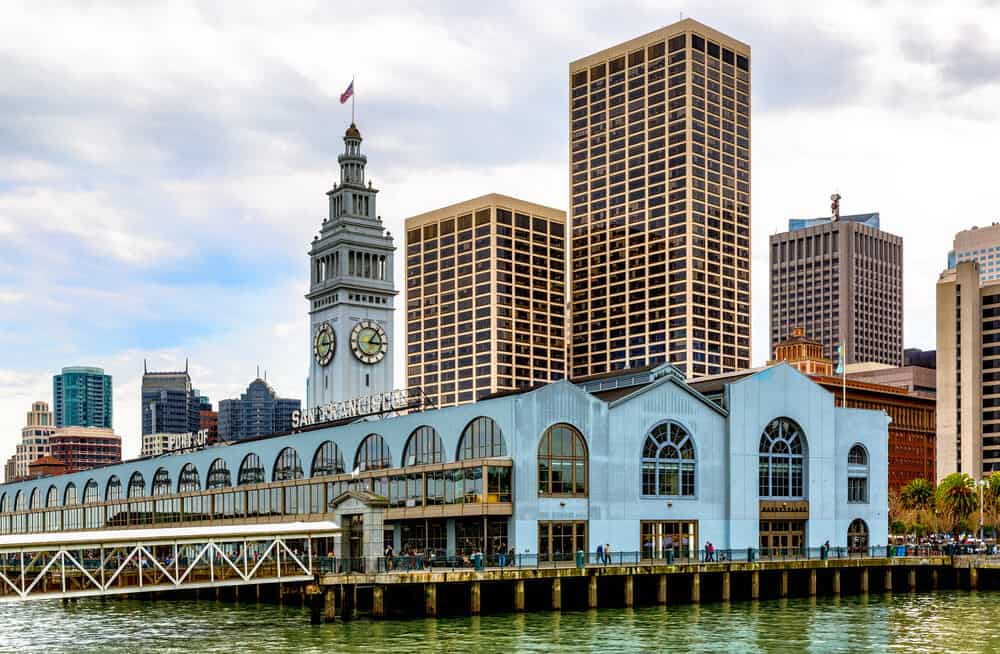 Ferry building with signature clock tower, with text that says "San Francisco" on the building. A popular weekend date in San Francisco idea.