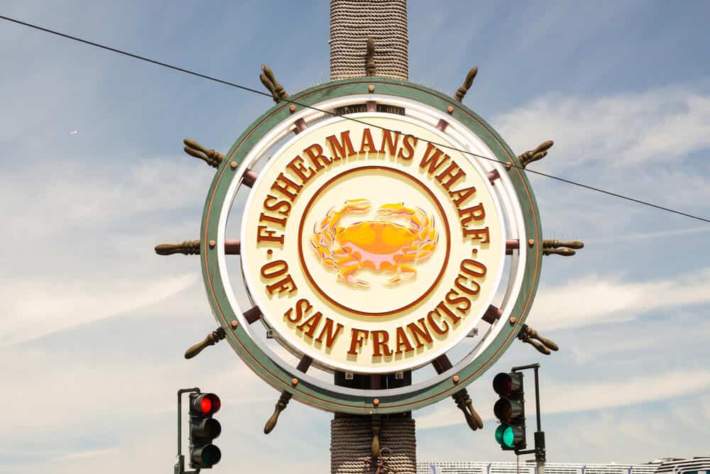 Sign that reads Fishermans Wharf of San Francisco in the shape of a wheel of a ship