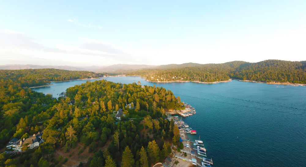 the charming lake arrowhead in california with trees and water