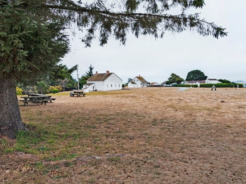 White houses and picnic tables make up part of the Fort Humboldt State Park near Eureka