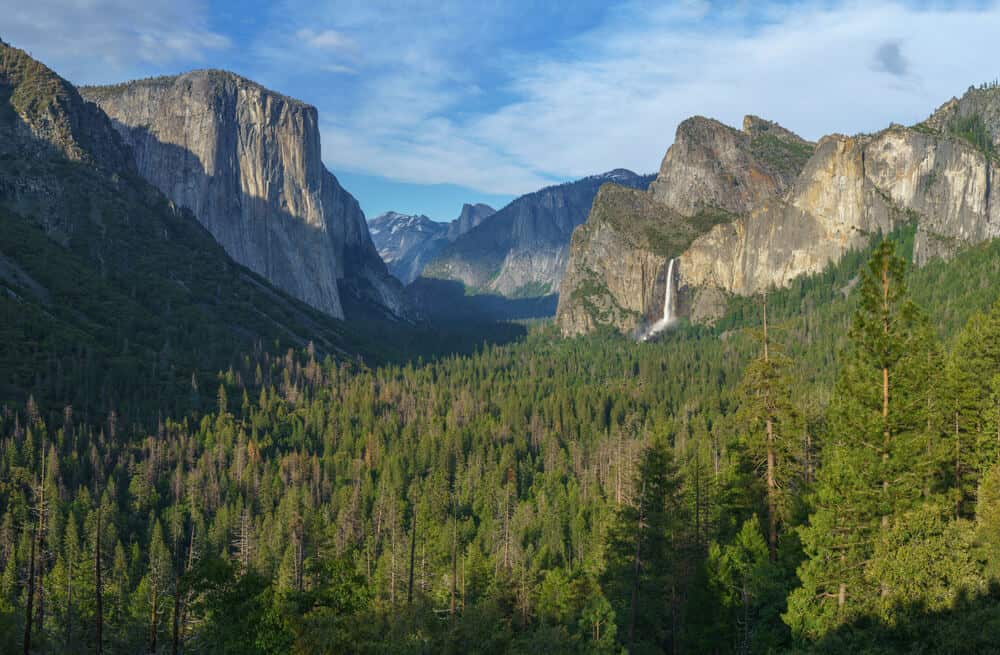 The famous Yosemite Tunnel View, a popular lookout spot with views of waterfalls, granite cliffs, evergreen trees, and more.