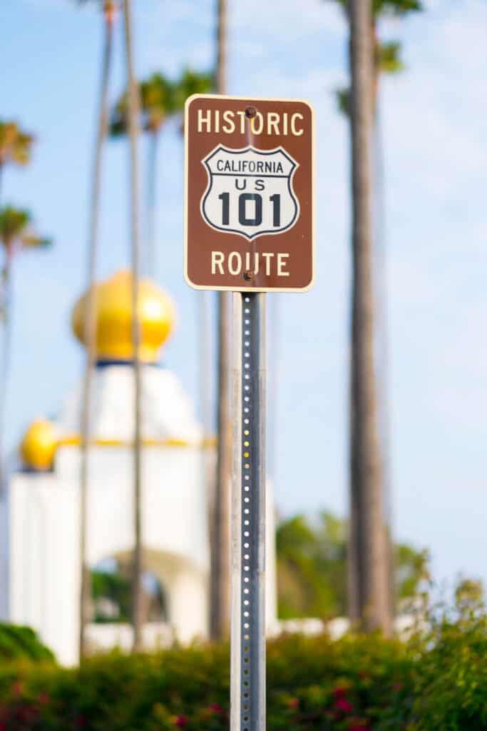 historic highway 101 sign in encinitas with palm trees and downtown in background