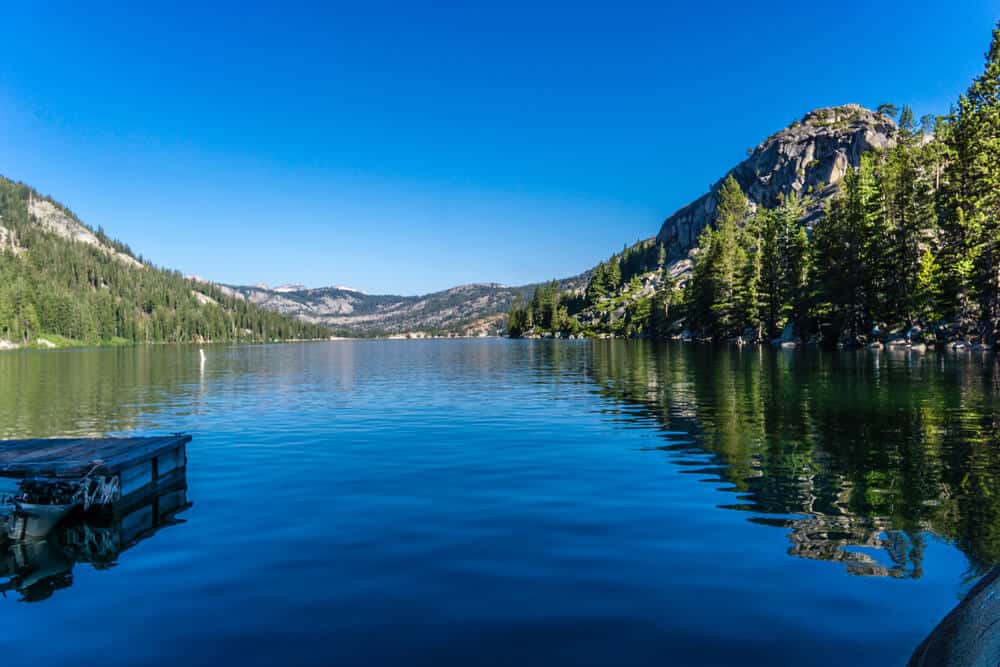 Dark blue waters of Echo Lake gently reflecting the scenery back