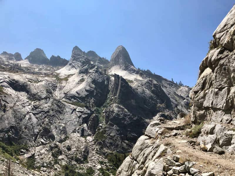 The High Sierra Trail in the Sierra Nevada Mountains and Sequoia National Park. Rocky mountainous landscape with a hiking trail edging along the mountain.