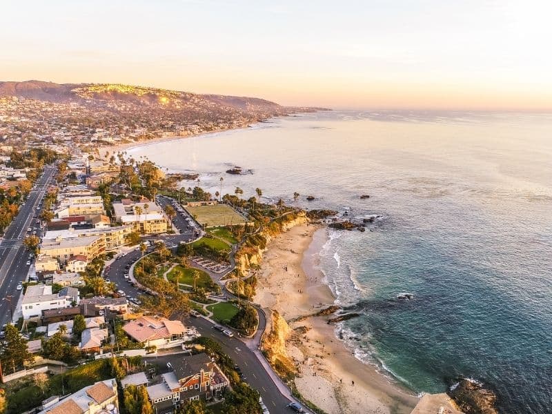 Sunset over Laguna Beach's waterfront and beachfront with a view of roads and the Pacific Coast Highway