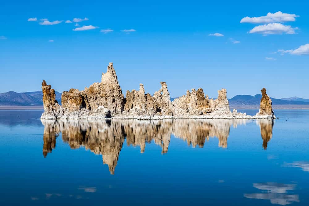 Deep blue glassy water, very salty and buoyant at Mono Lake, with tufa formations forming what looks like a castle rising out of the water