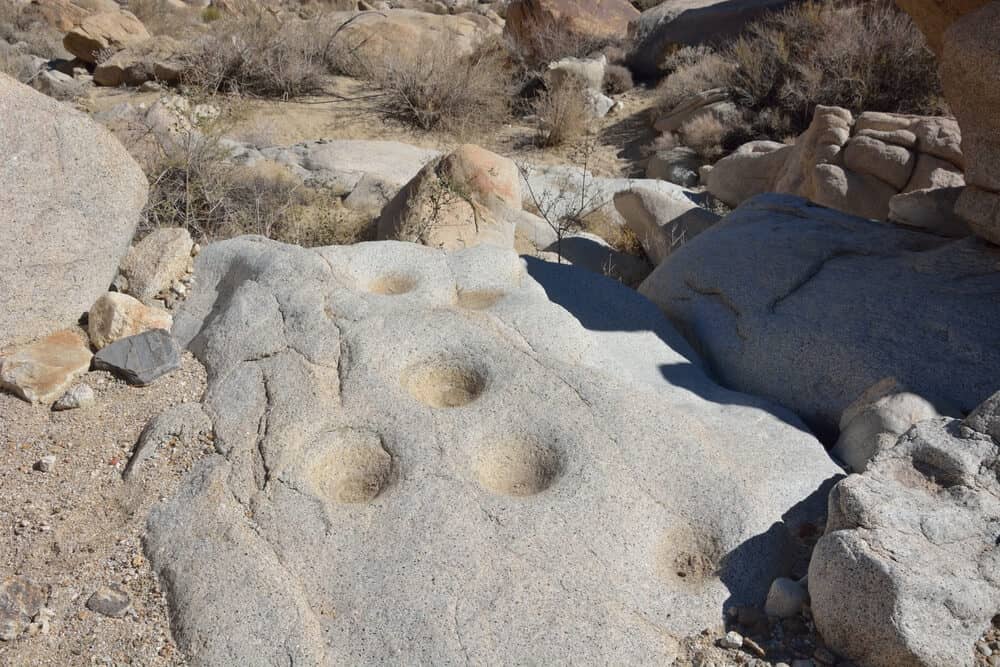 Several mortars carved into a stone by indigenous tribes who used the stone as a tool in the Anza Borrego desert