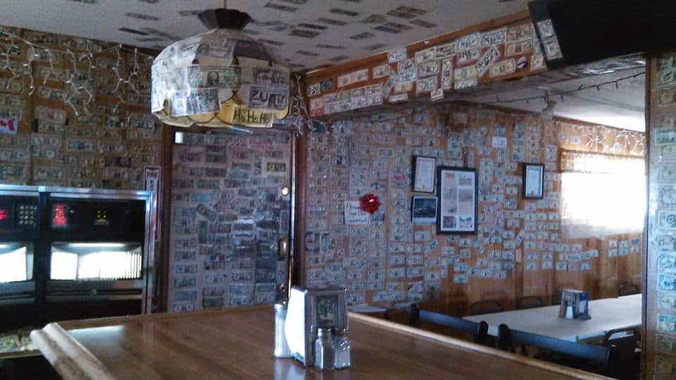 interior of a bar covered in dollar bills