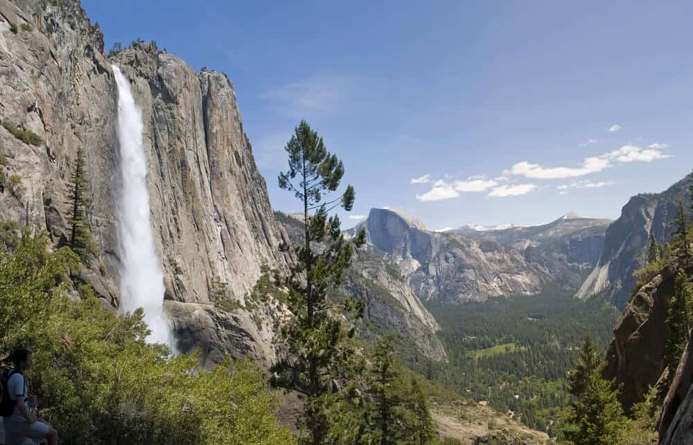 waterfall cascading over yosemite granite domes down into the valley below