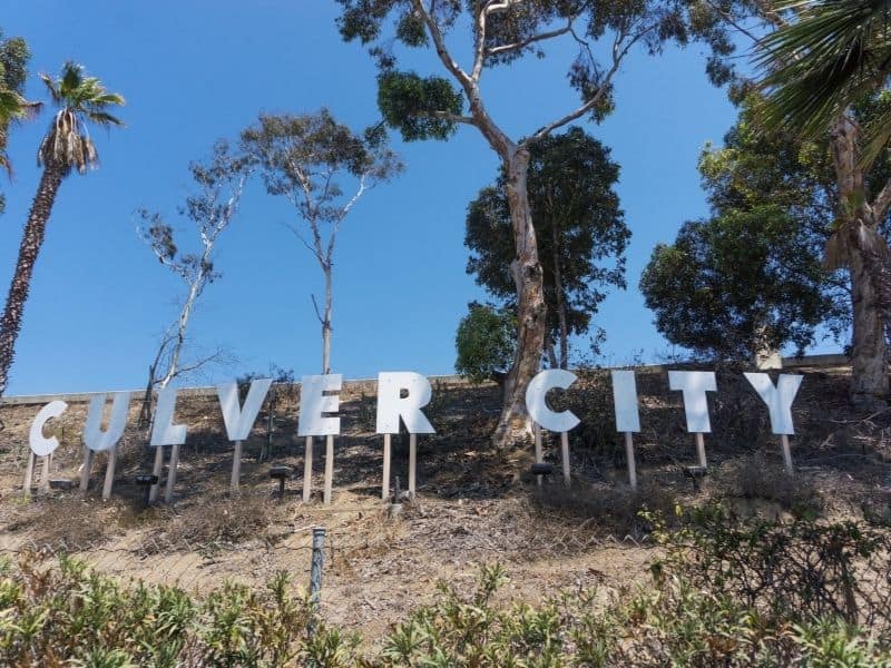 sign for culver city surrounded by brush and trees