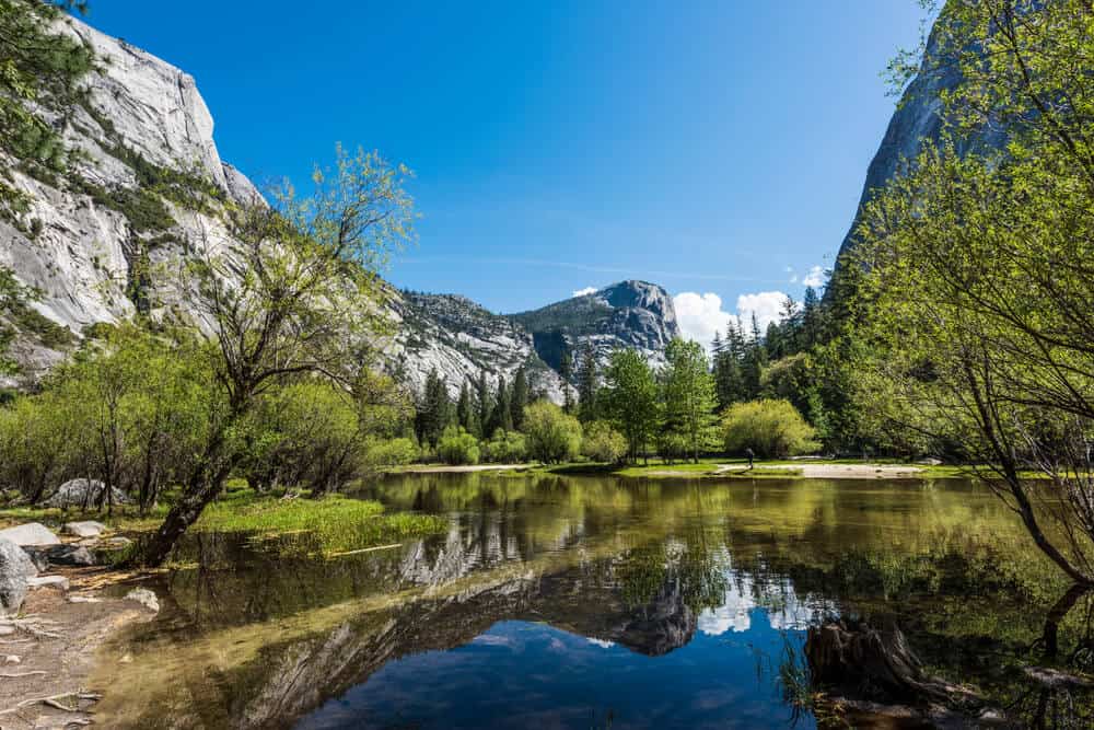 the beautiful still waters of mirror lake in yosemite valley, a top hike