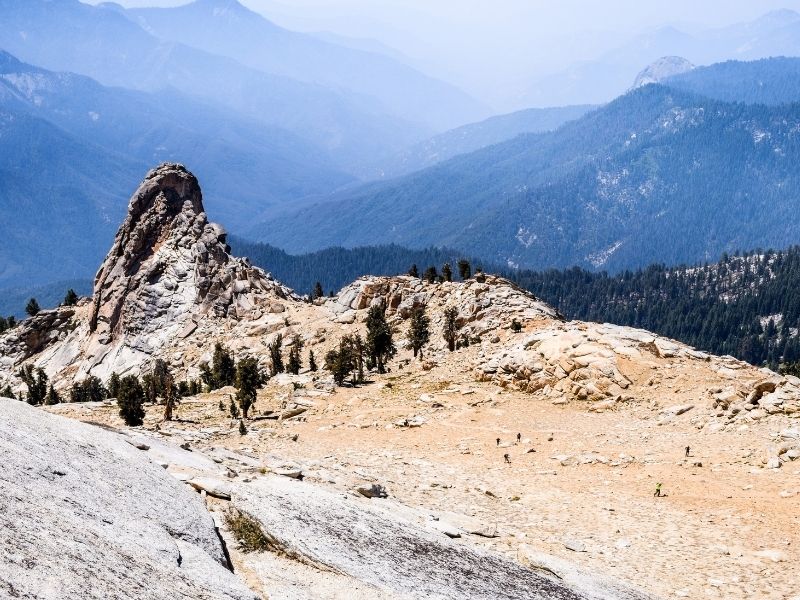 hiking along the trail to alta peak with mountains in the backround