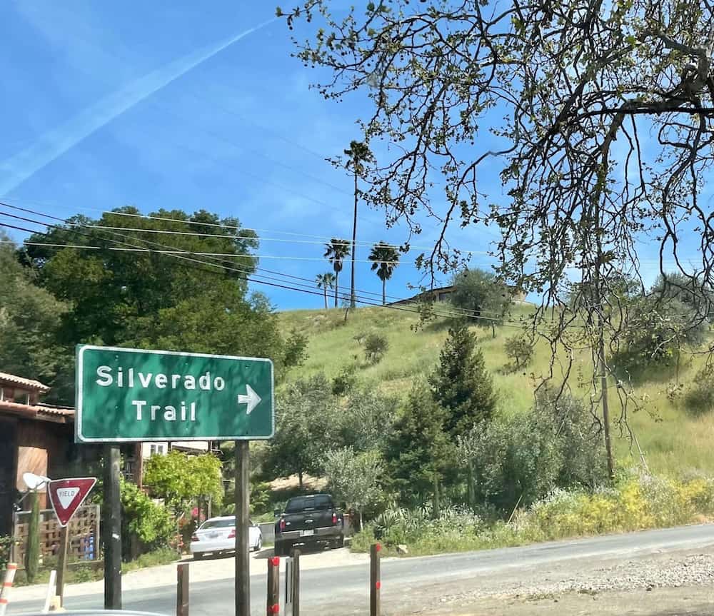 green and white sign that reads 'silverado trail' on a road in Calistoga California 