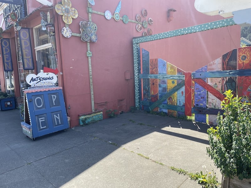 a painted fence that leads to art studios