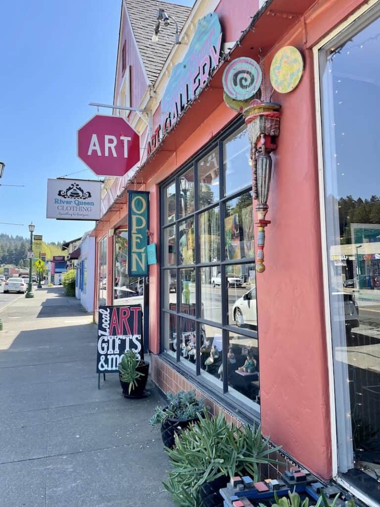 a red-painted art gallery with a sign that looks like a stop sign but says 'art' instead of stop