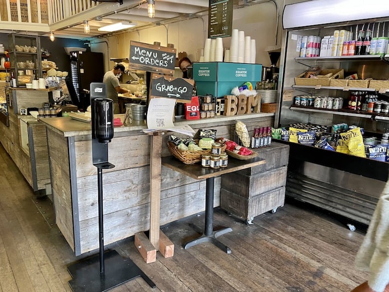 a view inside a cute little market selling sandwiches drinks and chips