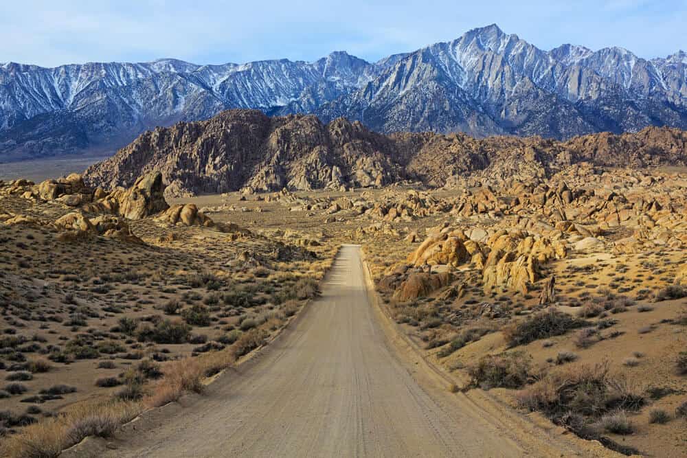 view of the famous road to the Alabama hills with a dirt road leading to the mountains and hills