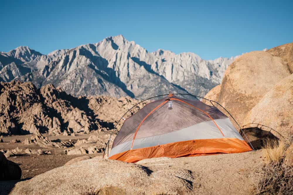 Camping in Alabama Hills, California with tent overlooking the Sierra Nevada mountains