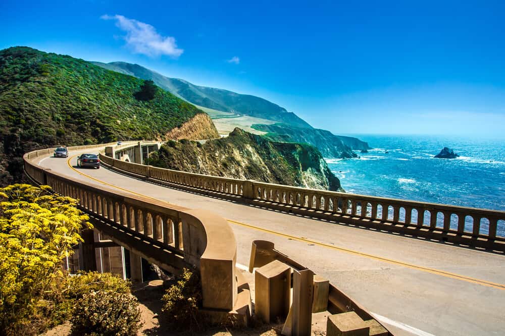 road tripping through big sur, crossing bixby creek bridge en route to the most scenic big sur hikes