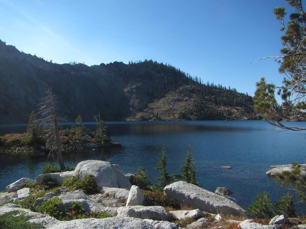 view of large boulders next to a turquoise lake