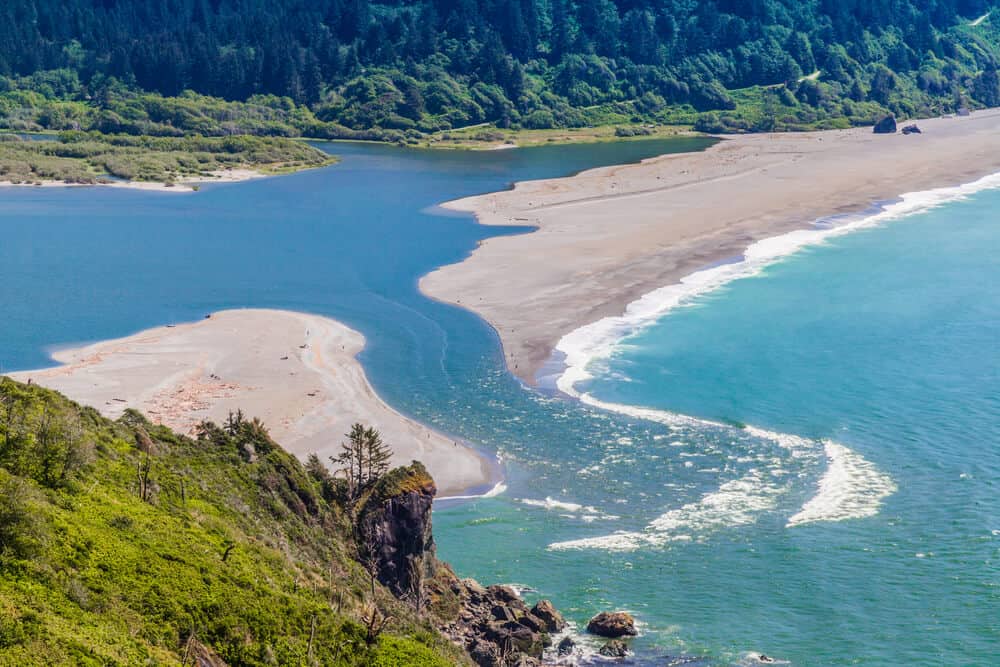 Klamath River emptying out into the Pacific Ocean, breaking apart a beach into two parts