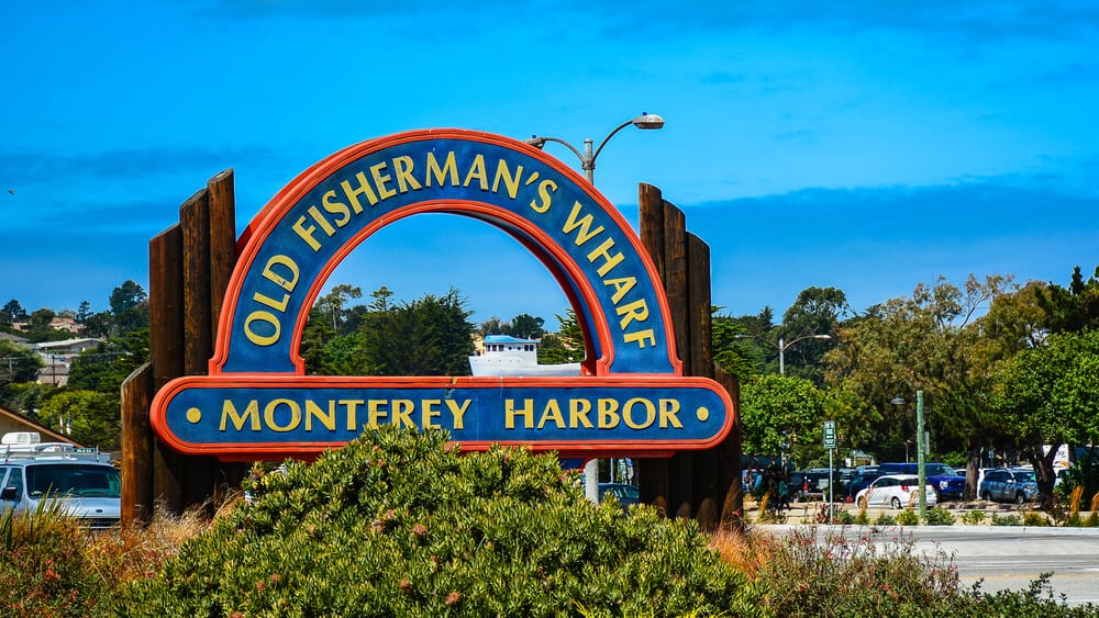 the sign for monterey california at the entrance to town on a sunny day