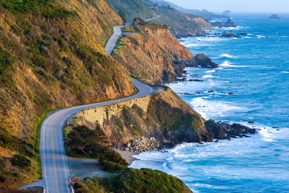 the twisting road of the pacific coast highway aka highway 1 along the pacific ocean with rocky shore