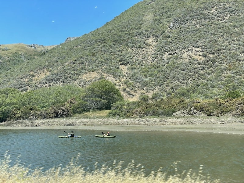 Two kayakers out on the water in Tomales Bay