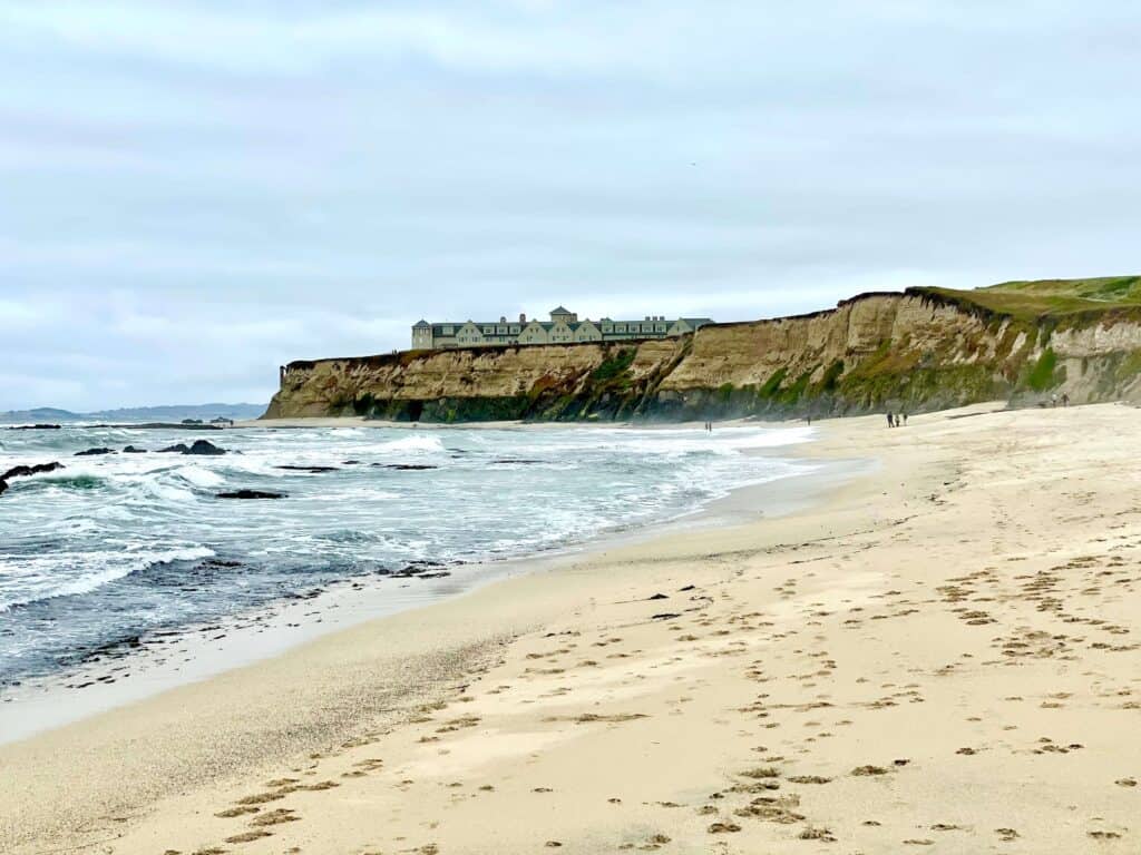 The beautiful ocean and sand of Manhattan Beach near the Ritz Carlton with the hotel standing on the bluff