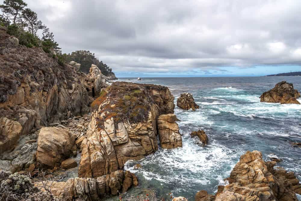 Whaler's Cove at Point Lobos State Reserve, with aquamarine waters & rock formations, huge waves, along the rugged Big Sur coastline