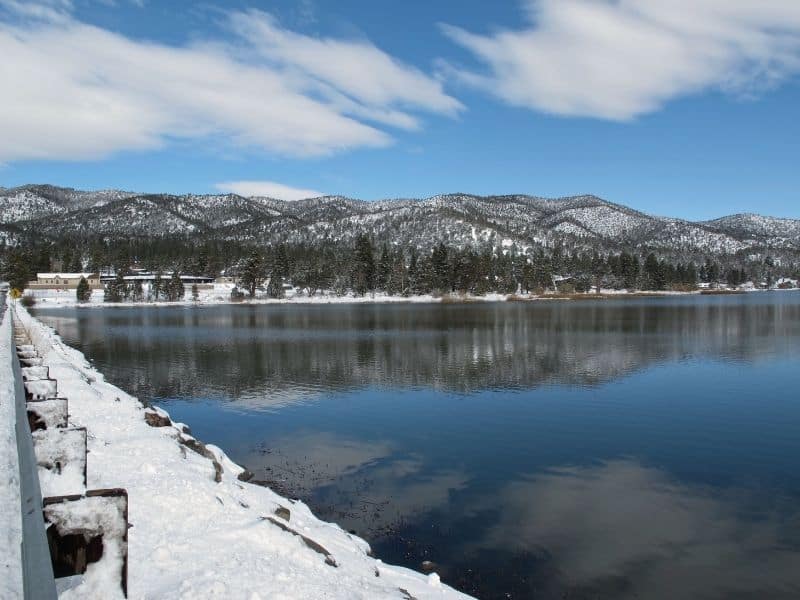 big bear lake in winter with snowfall and clear skies