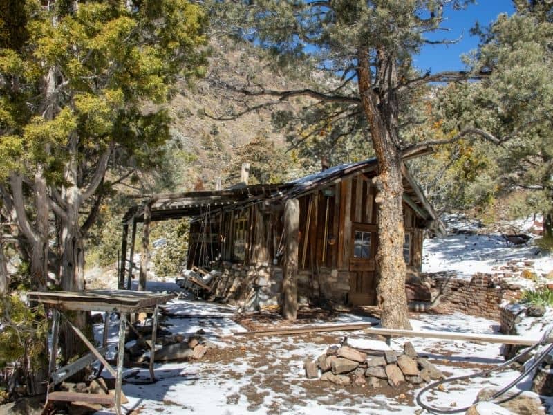 A wooden shack in Panamint City with some snow on the ground in winter